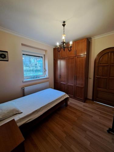 a bedroom with a bed and a wooden cabinet at Ramonda house in Brestovik