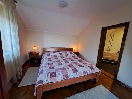 a bedroom with a bed and a mirror at Ramonda house in Brestovik
