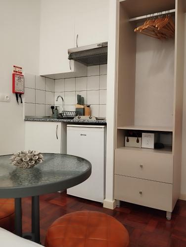 a kitchen with a table and a counter top at Bella Vista in Funchal