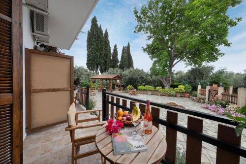 a table with a bowl of fruit on a balcony at Vergonis Studios in Koropi