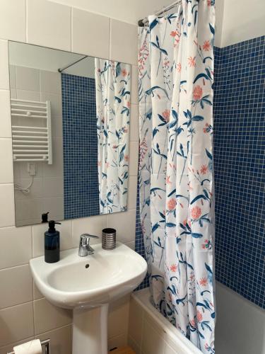 a bathroom with a sink and a shower curtain at Bella Vista in Funchal