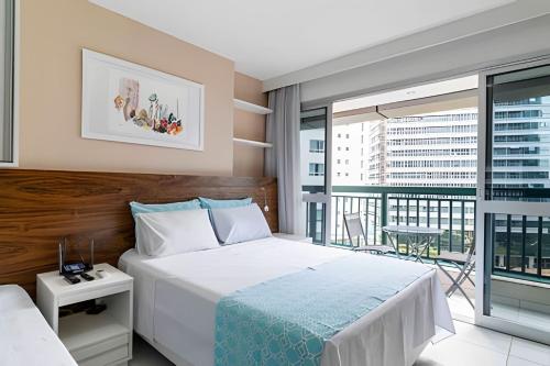 a bedroom with a large bed and a balcony at Hotel VISION in Brasilia