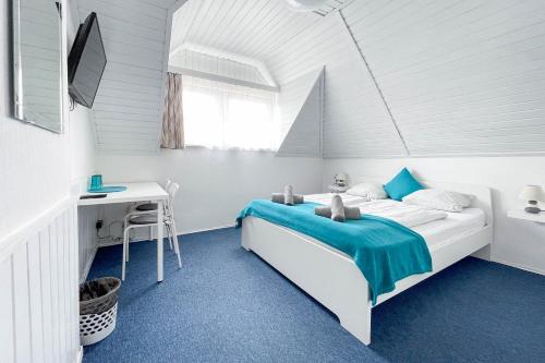 a white bedroom with a bed and a desk at Manna Villa in Balatonfüred