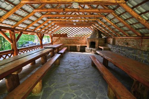a group of wooden benches in a pavilion at Chatová Osada Zrub in Vinné