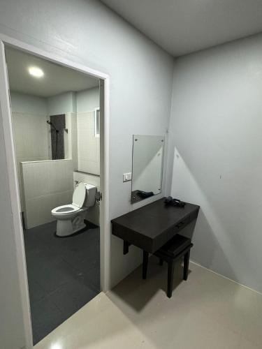 a bathroom with a toilet and a sink and a mirror at Mimi Home in Ko Yao Noi