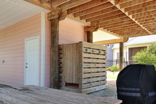 a wooden pergola on the side of a house at Turtle Town by Pristine Properties Vacation Rentals in Indian Pass