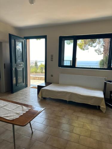 a bedroom with a bed and two large windows at Marble Home in Egira