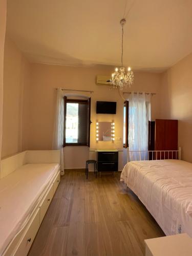 a bedroom with two beds and a desk at AF Guest House in Areopolis