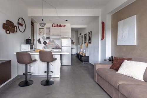 a living room with a couch and a kitchen at Radio Hotel in Rome