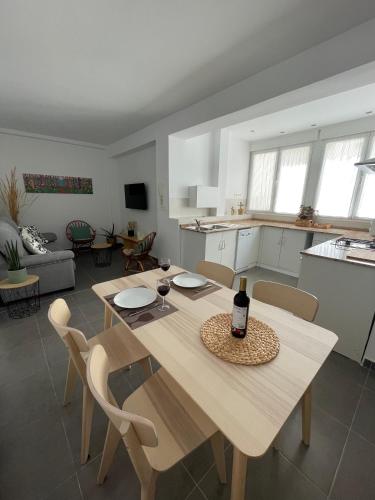 a table with a bottle of wine on it in a living room at Luxury apartment close to everything in Granada