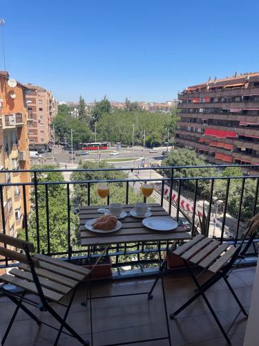 a balcony with a table and two glasses of wine at Luxury apartment close to everything in Granada