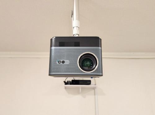 a small speaker hanging from a ceiling at Lucy Stay in Seoul