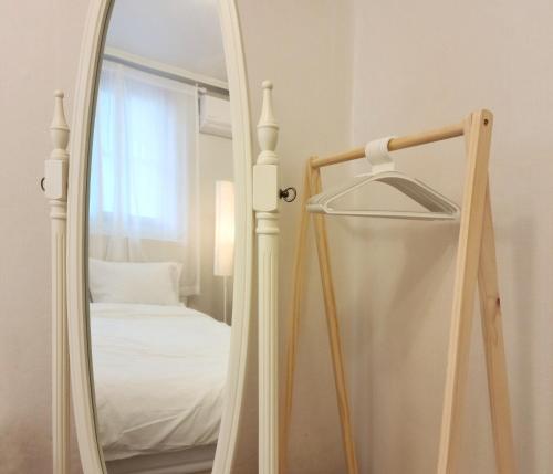 a mirror next to a bed in a room at Lucy Stay in Seoul
