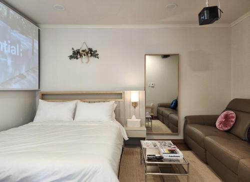 a hotel room with a bed and a couch at Lucy Stay in Seoul