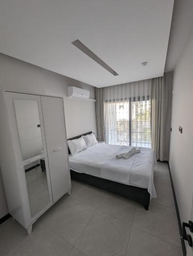 a bedroom with a large bed and a window at Villa Begonvil in Kuşadası