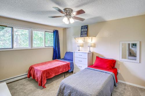 a bedroom with two beds and a ceiling fan at Spacious Eagle River Escape with Hot Tub and Views! in Eagle River