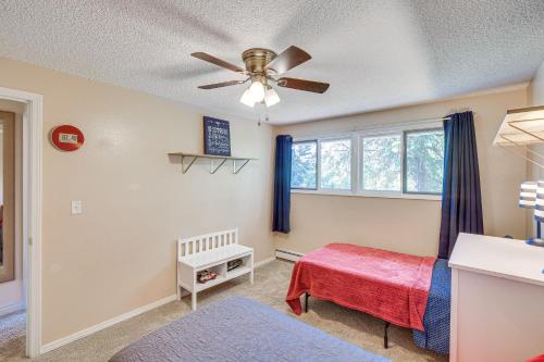 a bedroom with a bed and a ceiling fan at Spacious Eagle River Escape with Hot Tub and Views! in Eagle River