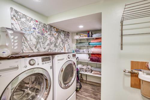 a laundry room with a washer and dryer at Spacious Eagle River Escape with Hot Tub and Views! in Eagle River