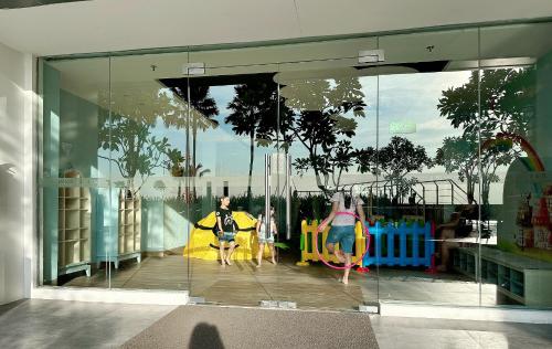 two children playing on a playground in a store window at Apartemen Benson Studio Plus in Surabaya