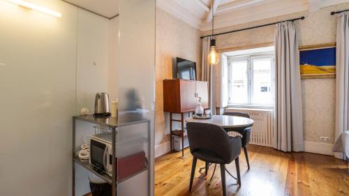 a living room with a table and a dining room at The Brewmaster's House in Porto