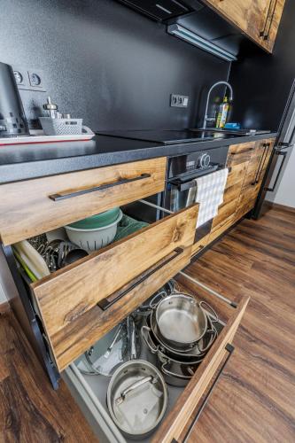 an open drawer in a kitchen with a stove at HP APARTMÁNY SKIAREÁL- Buková Hora v Orlických horách 100 m od lanovky in Červená Voda