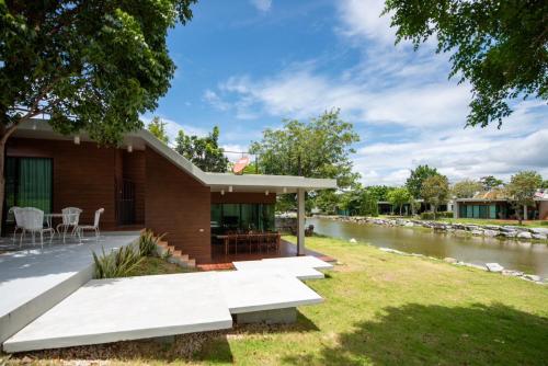a house with a river behind it at Lake paradise villa khaoyai LB4 in Ban Rai Khlong Sai