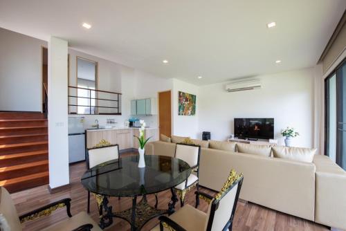 a living room with a table and a couch at Lake paradise villa khaoyai LB4 in Ban Rai Khlong Sai