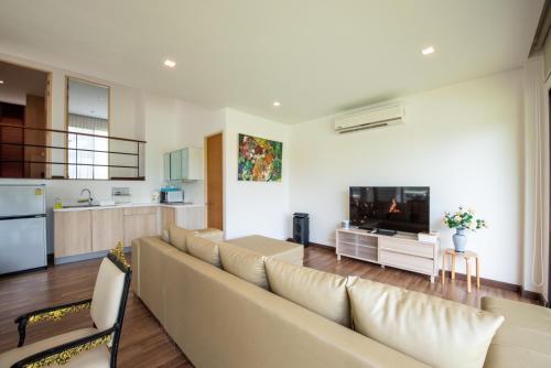 a living room with a couch and a television at Lake paradise villa khaoyai LB4 in Ban Rai Khlong Sai