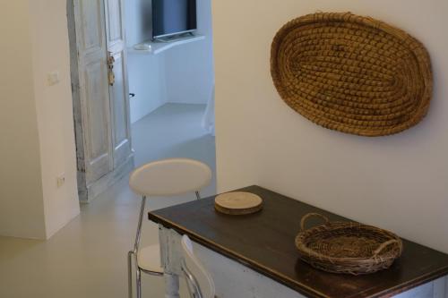 Una habitación con una mesa con dos cestas en la pared. en L'Arco delle Fogge - Suite con Terrazzo Esclusivo, en Fasano