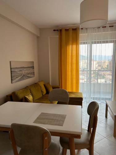 a living room with a table and a couch at Water Lily Apartments in Vlorë