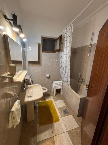 a bathroom with a sink and a shower and a tub at Apartments Renata in Pučišća