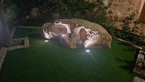an elephant statue sitting on the grass at night at Villa Teresa in Oschiri