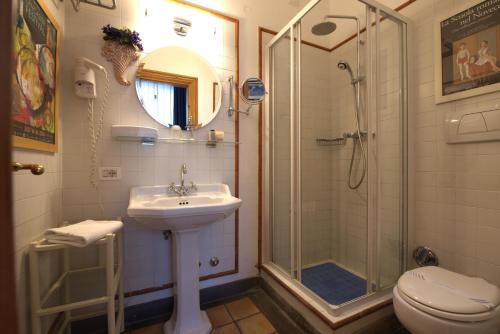 a bathroom with a sink and a shower and a toilet at Hotel Locanda Cairoli in Rome