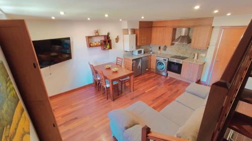 a living room and kitchen with a couch and a table at Cabirol in Camprodon