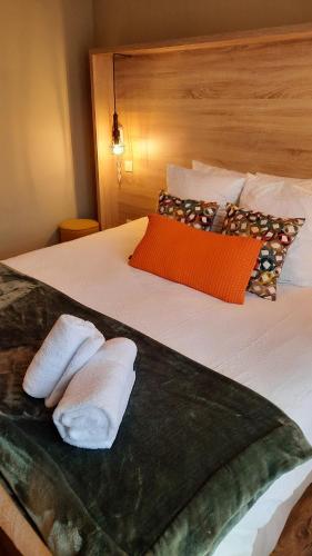 a bedroom with two towels on a bed at Hotel Mendionde in Saint-Pée-sur-Nivelle