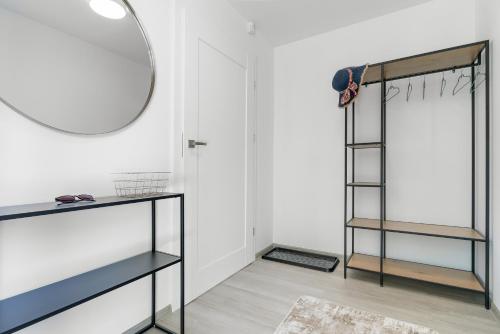 a room with a mirror and a glass shelf at Morze Ciszy in Dziwnów