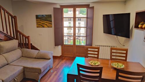 a living room with a couch and a table at Cabirol in Camprodon