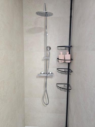 a shower with three shelves in a bathroom at Holiday Home KyDo - Heated Pool - Roof Terrace - San Pedro del Pinatar in San Pedro del Pinatar