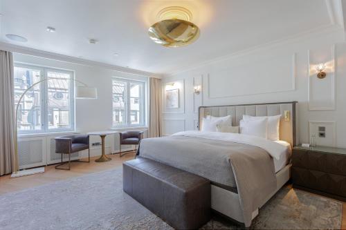 a bedroom with a large bed and a table at The Hotel Maria Helsinki in Helsinki