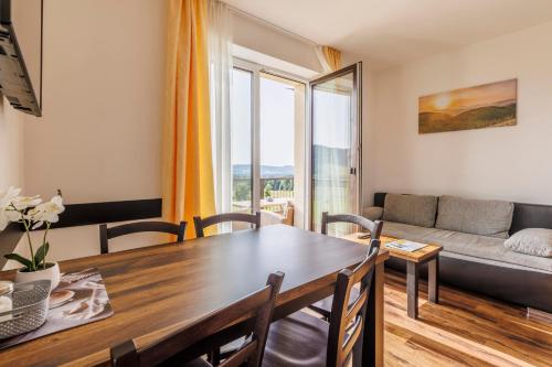 a living room with a table and a couch at HP APARTMÁNY SKIAREÁL- Buková Hora v Orlických horách 100 m od lanovky in Červená Voda