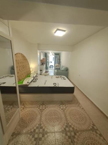 a room with a bed and a mirror in it at Apartamento MOTA 8 in Xeraco
