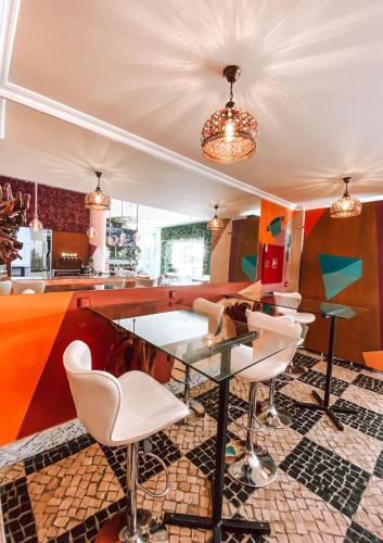 a kitchen with a glass table and chairs at Alentejo Marmòris Hotel & Spa in Vila Viçosa