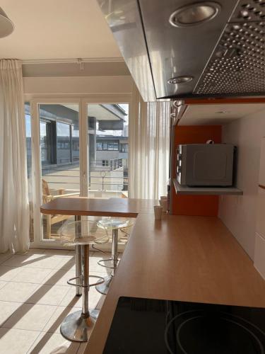 une cuisine avec une table et des chaises et un micro-ondes dans l'établissement T4 Chartrons Ravezies, à Bordeaux