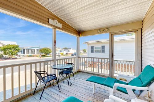 a patio with chairs and a table on a deck at Pop Pop's Place in Ocean City
