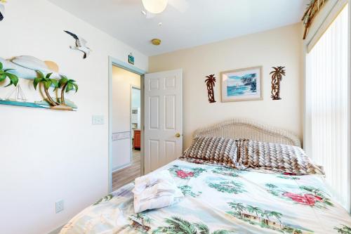 a bedroom with a bed with a colorful bedspread at Pop Pop's Place in Ocean City