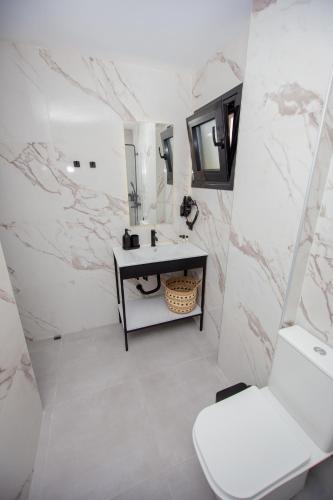 a bathroom with a sink and a toilet at LA PLAZA luxury suites NEA VRASNA in Nea Vrasna