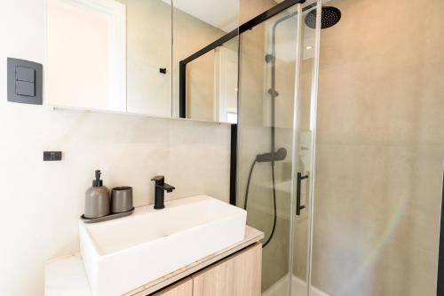 a bathroom with a sink and a shower at Luxury and Cosy Little House Ivinj 1 in Tisno