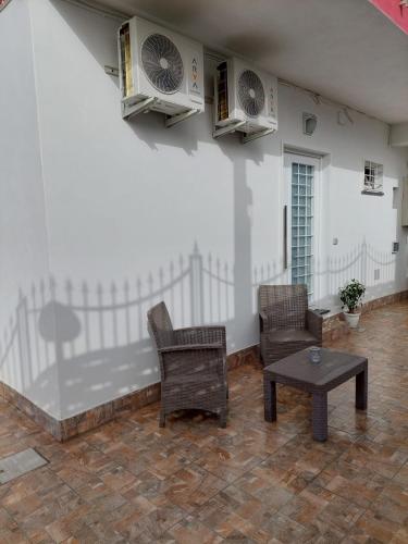 a living room with two chairs and a table at Gaia Pia Home in Bacoli