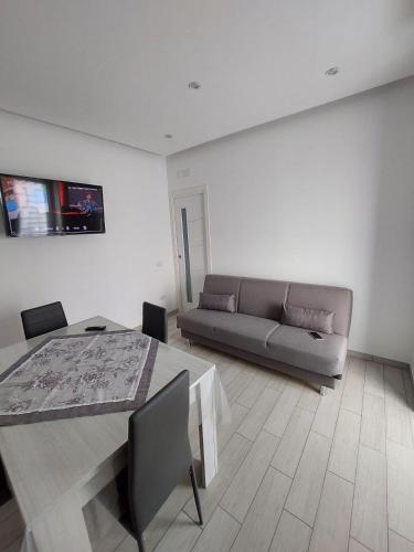 a living room with a couch and a table at Gaia Pia Home in Bacoli