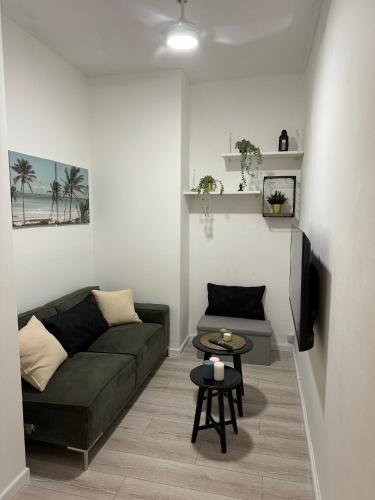 a living room with a couch and a table at 3 rooms apartment on the beach in Tel Aviv